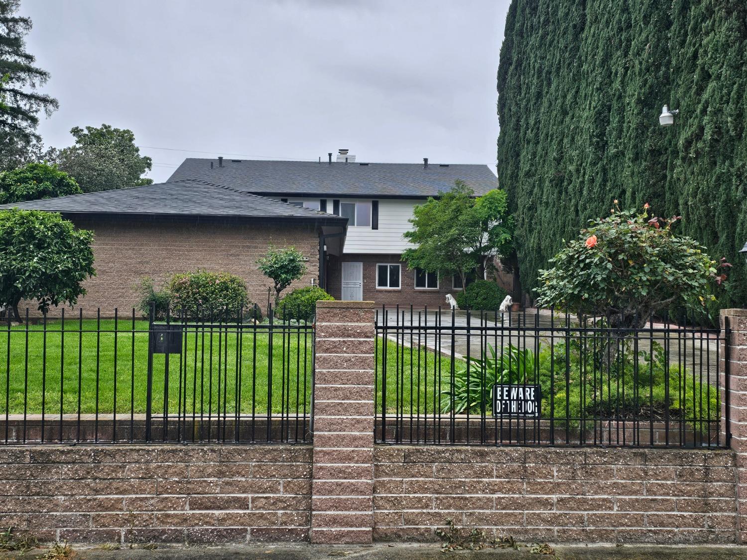 a view of a house with a small yard and plants