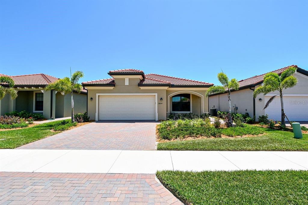 a front view of a house with a yard and a garage