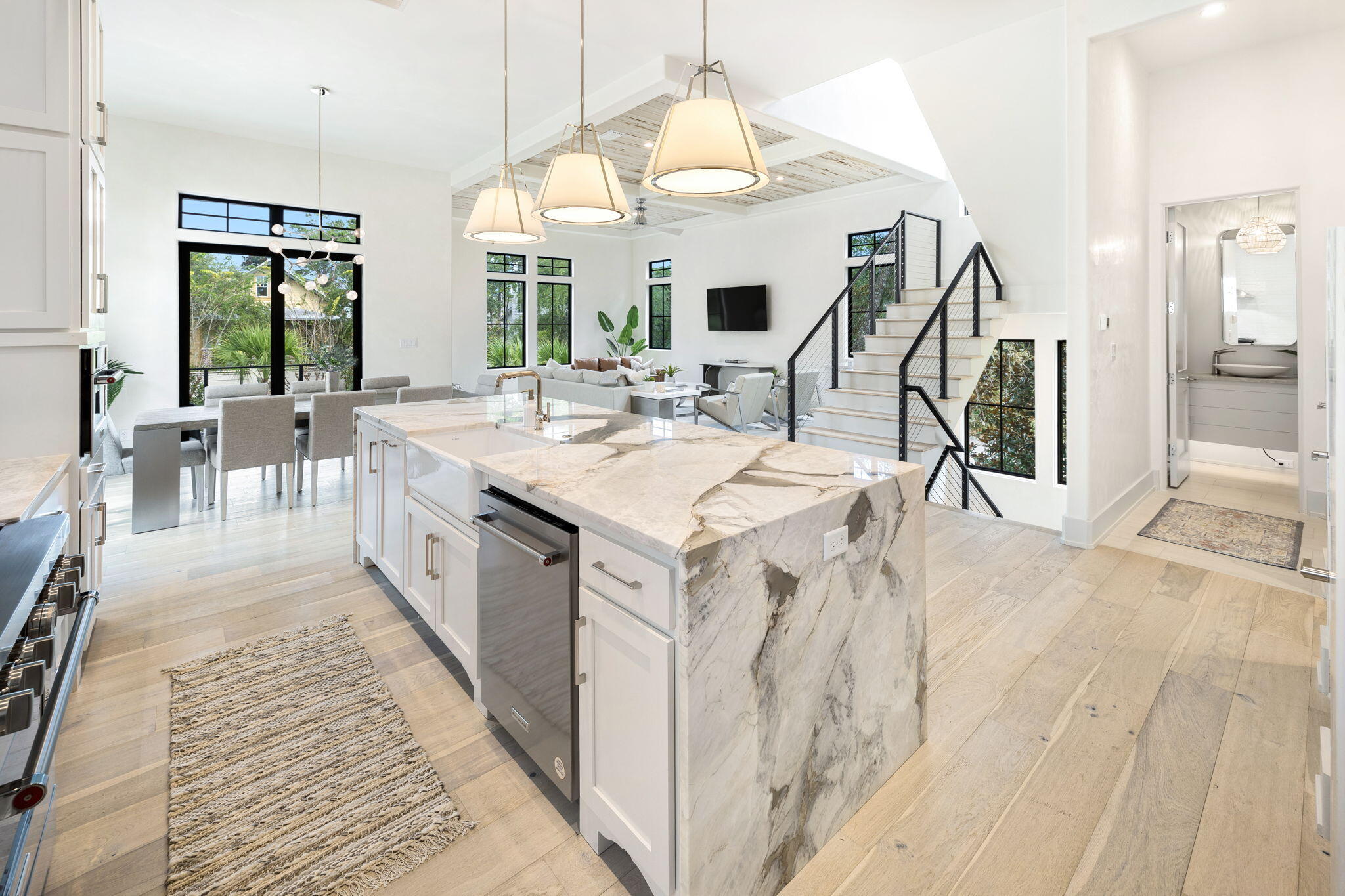 a large white kitchen with sink and white cabinets