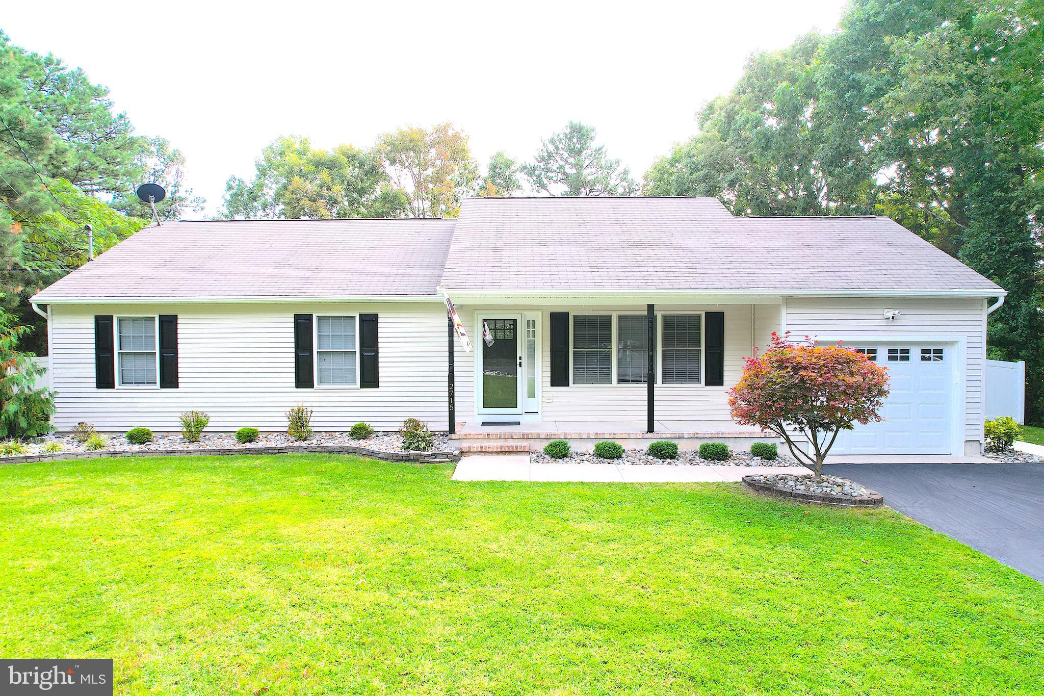 a front view of a house with a garden and porch