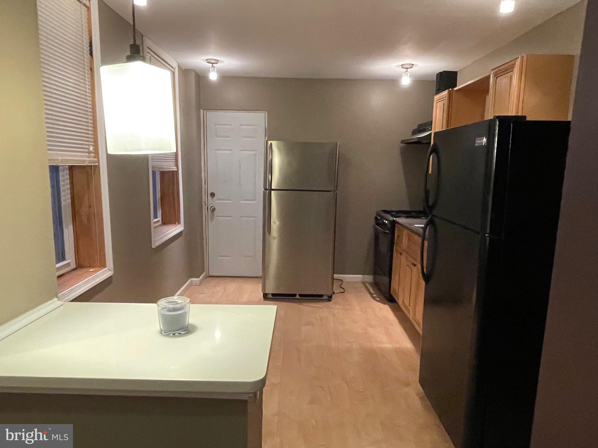 a kitchen with refrigerator and window