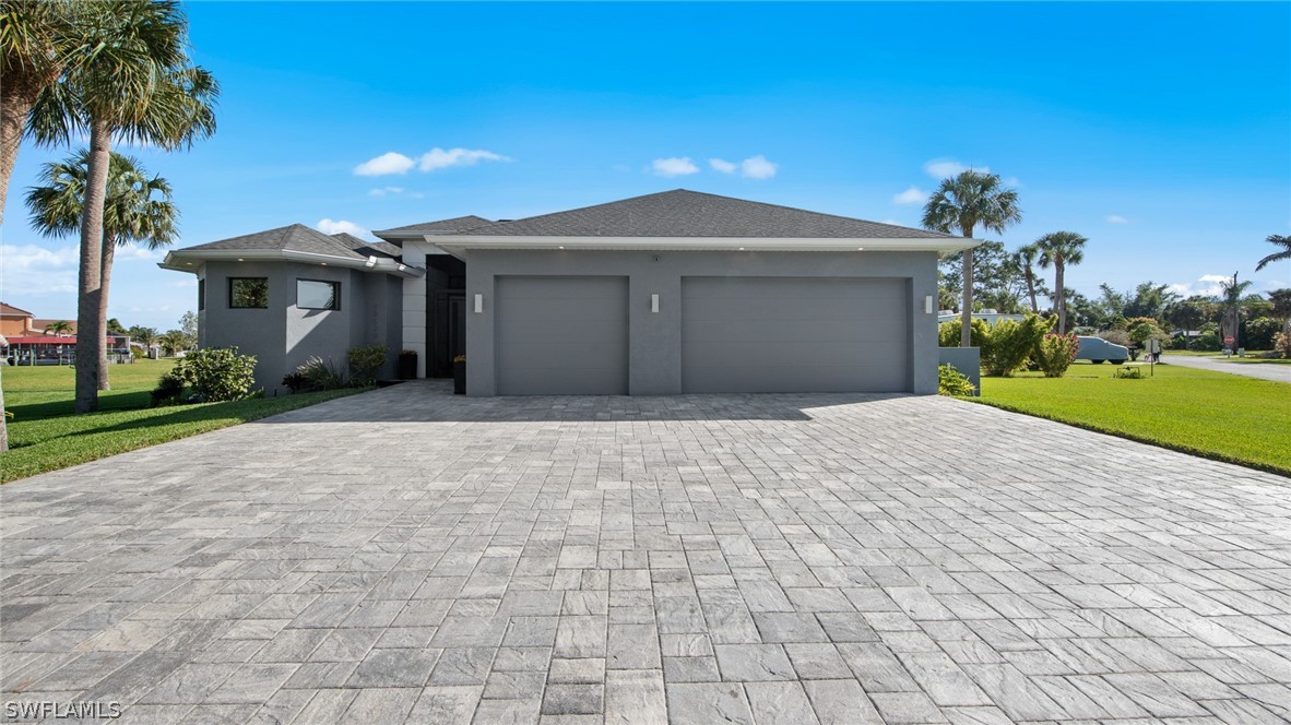 a front view of a house with a yard and a garage