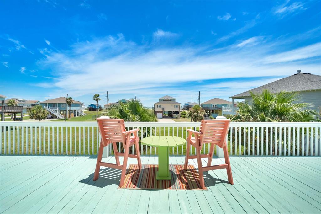 a view of a chair and table on the roof deck