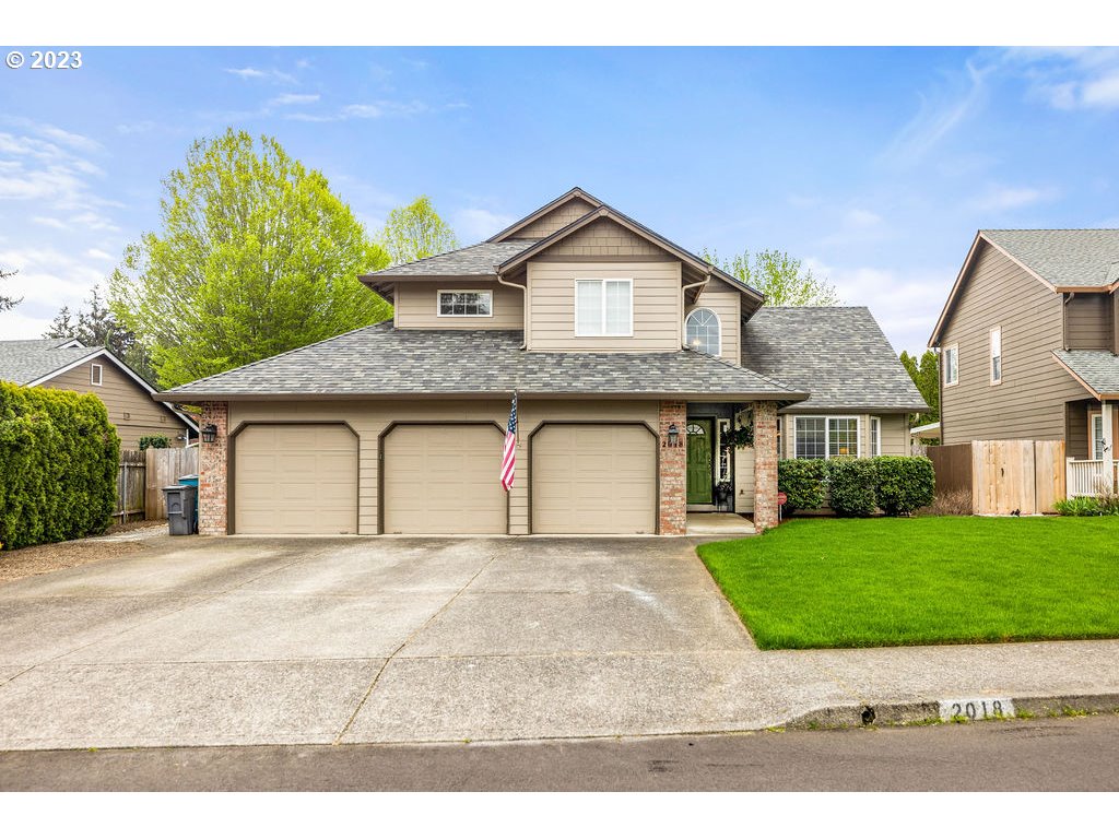 a front view of a house with a yard and garage