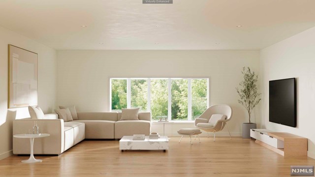 a living room with furniture flat screen tv and a large window