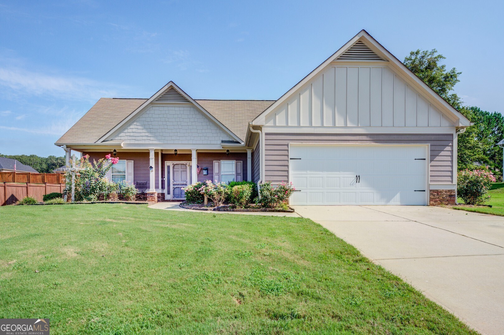 a front view of a house with yard patio and green space