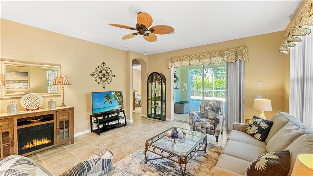 a living room with furniture a fireplace with a flat screen tv