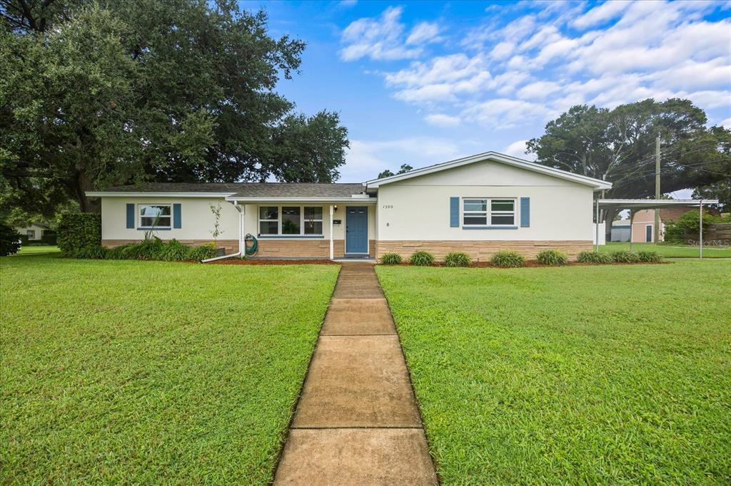 a front view of house with yard and green space