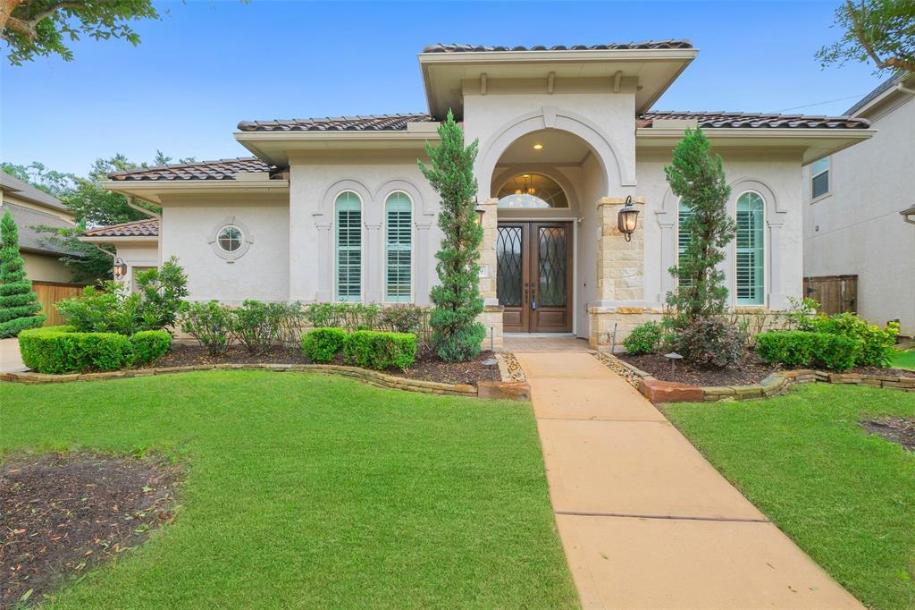 a front view of a house with garden