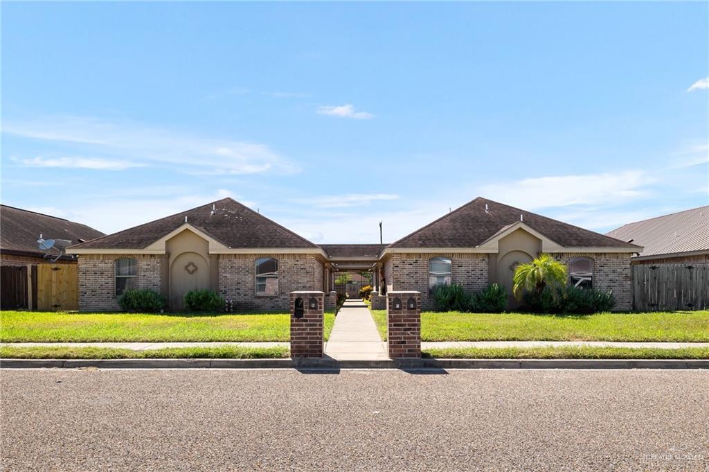 Single story home featuring a front lawn