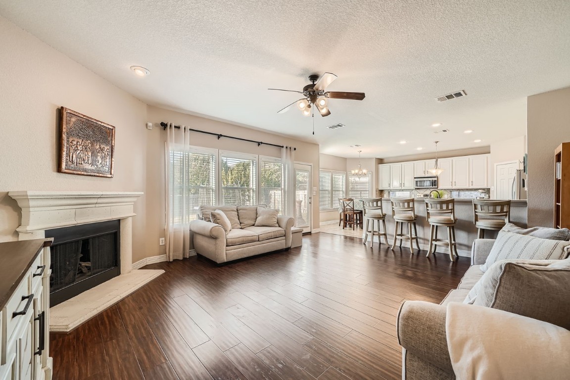 a living room with furniture wooden floor and a fireplace