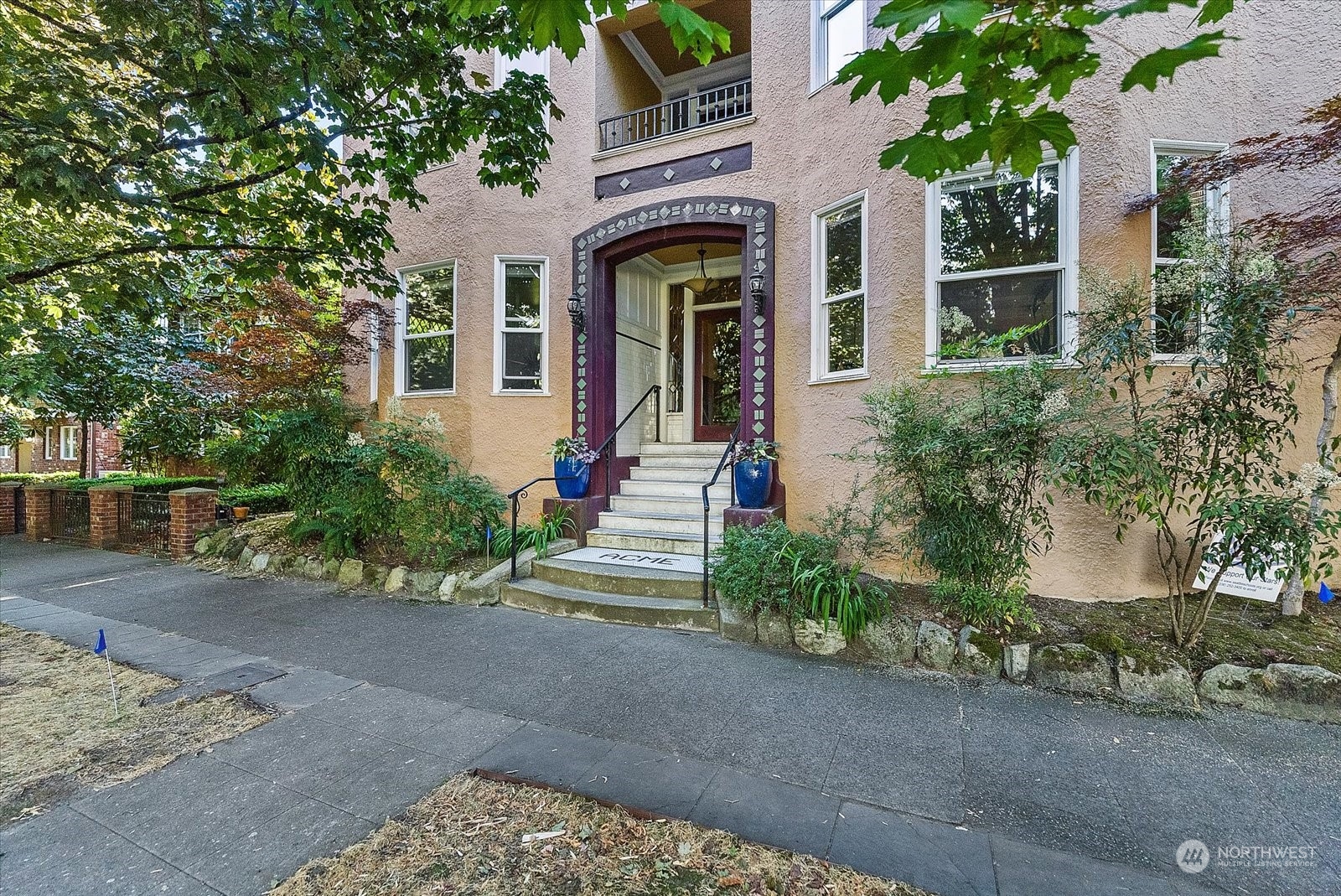 front view of a brick house with a yard