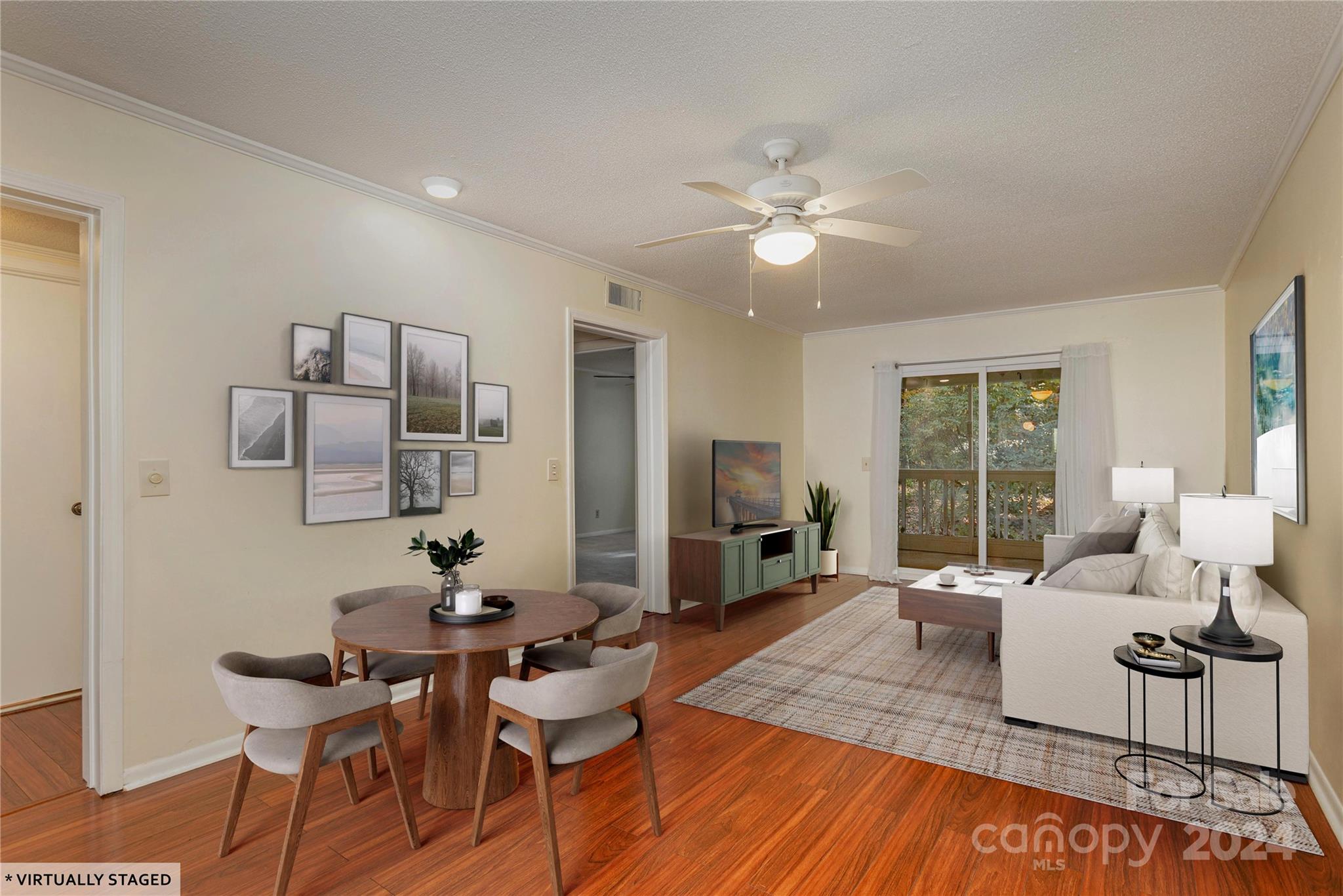 a living room with furniture and wooden floor