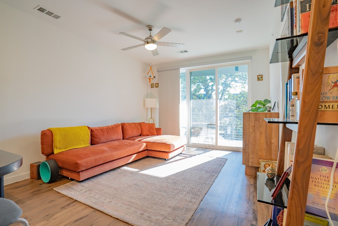 a living room with furniture and a lamp