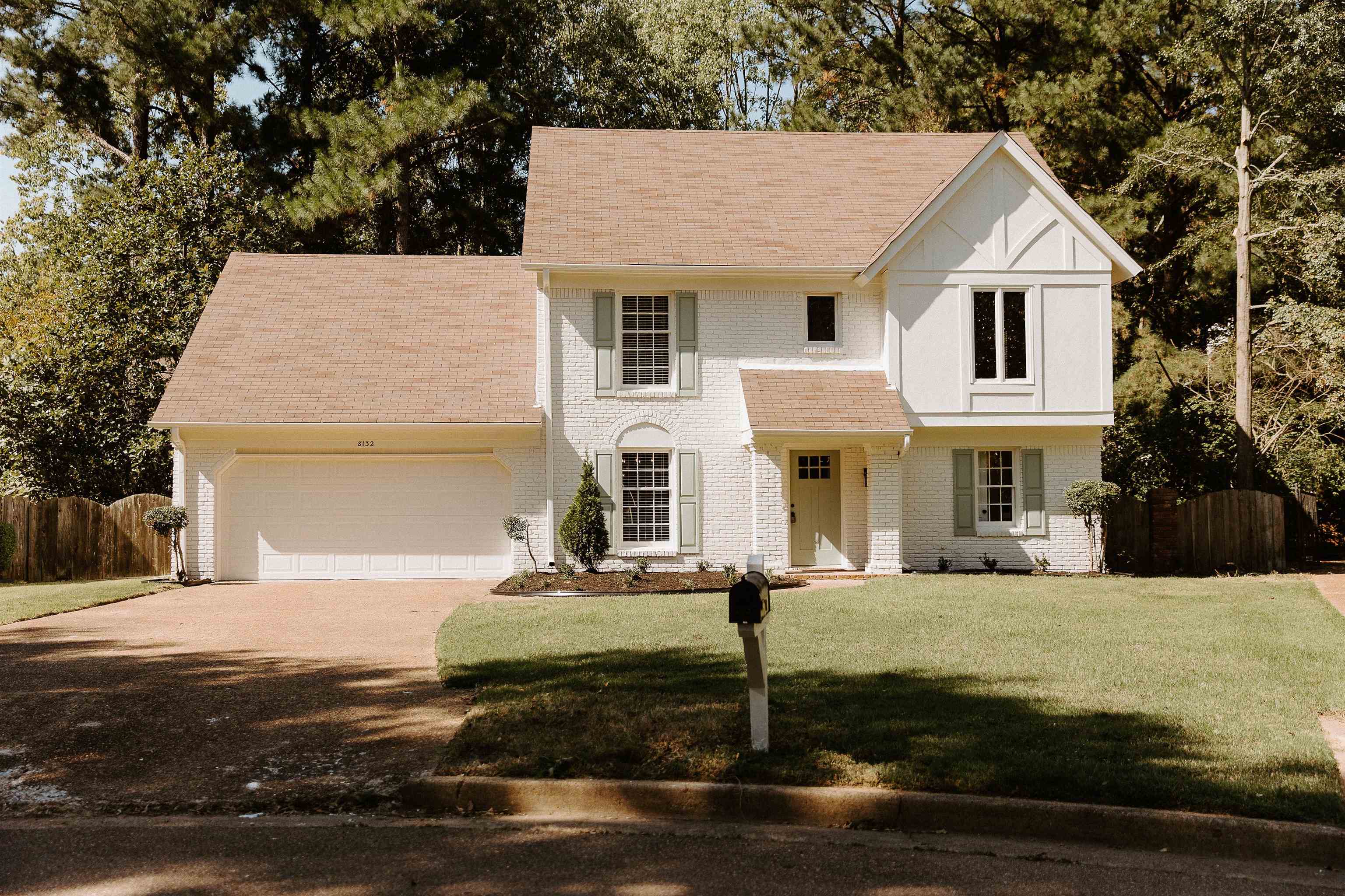 View of front of home featuring a garage and a front lawn