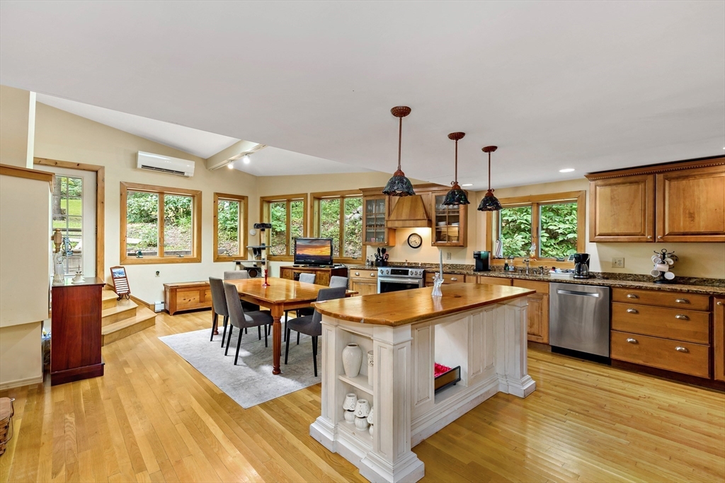 a large kitchen with stainless steel appliances granite countertop a stove and cabinets