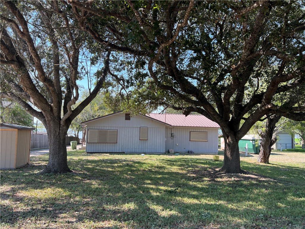 a house that has a tree in front of a house