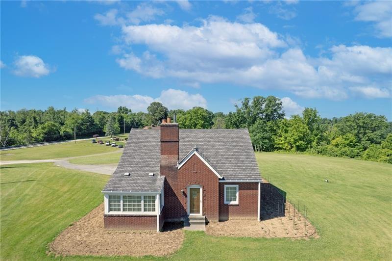 a aerial view of a house with a yard table and chairs