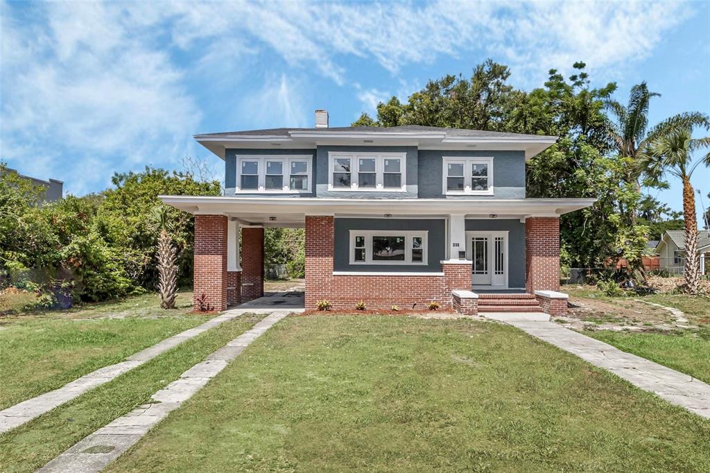 a front view of house with yard and green space