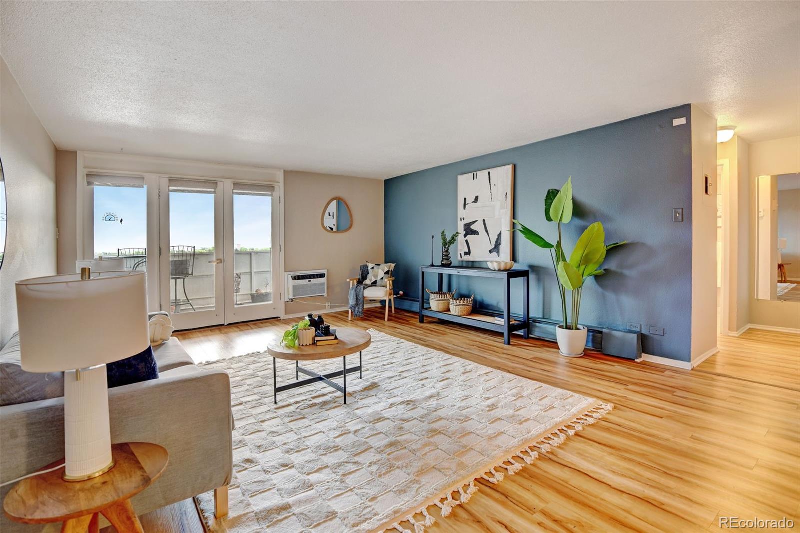 a living room with furniture and a wooden floor