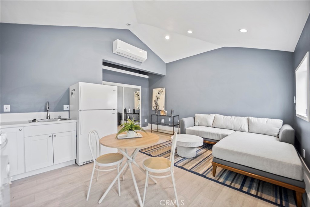 a living room with furniture a white wall and a stove top oven