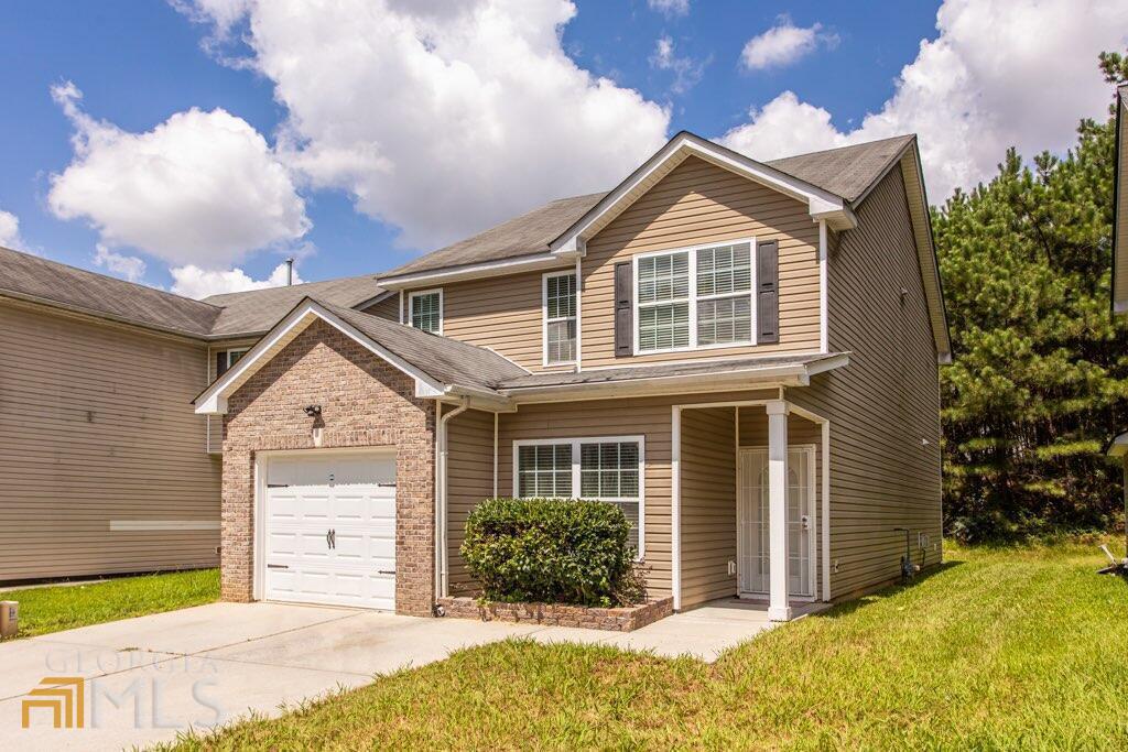 a front view of a house with a yard