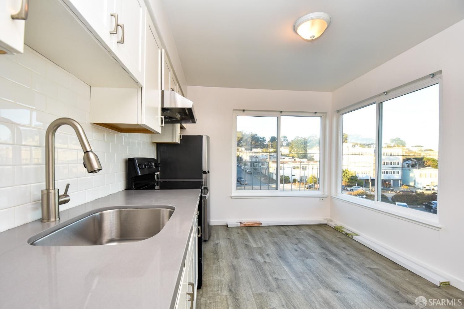 a kitchen with a sink a counter top space and a window