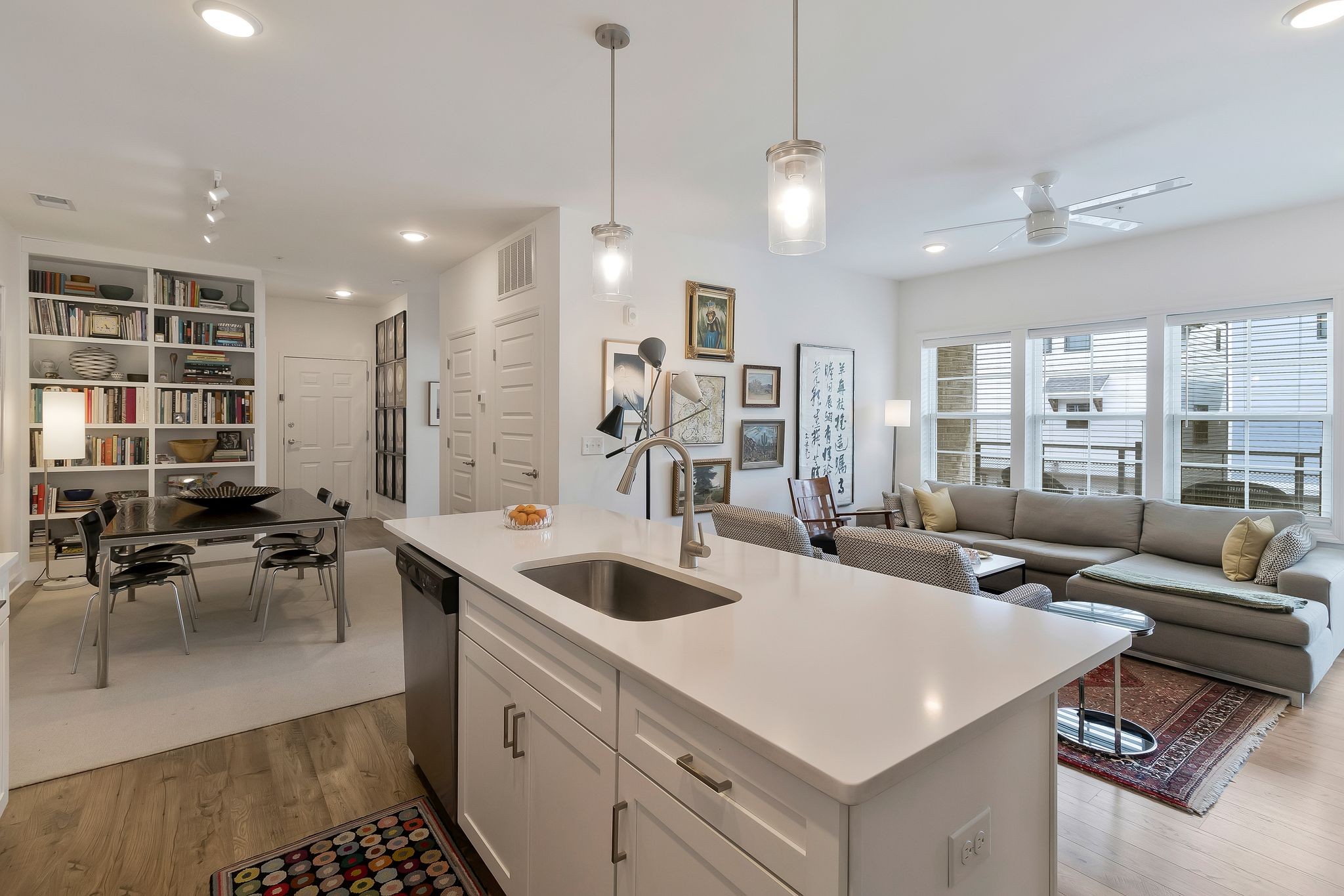 a large white kitchen with a large window