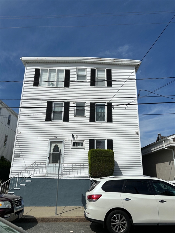 a front view of a house with parking space