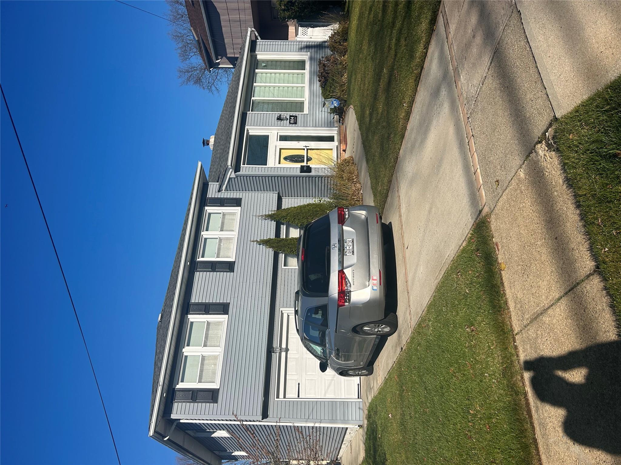 View of front of house with a garage and a front yard