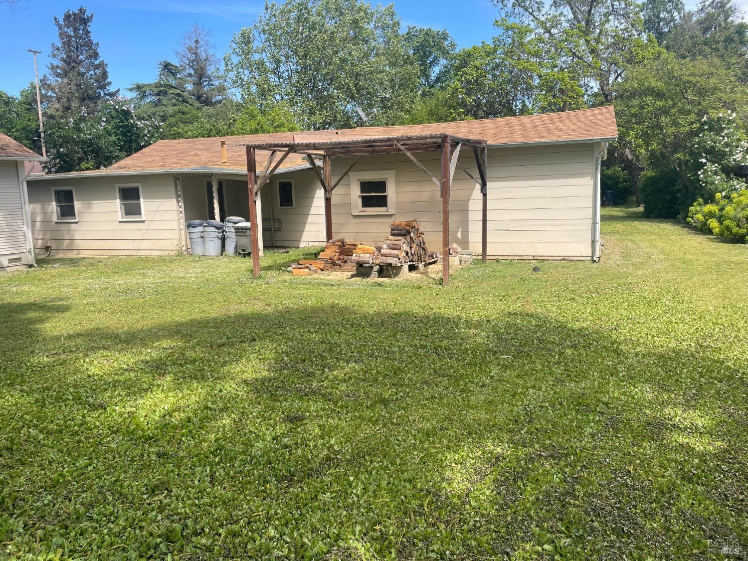 a view of a house with a yard and sitting area