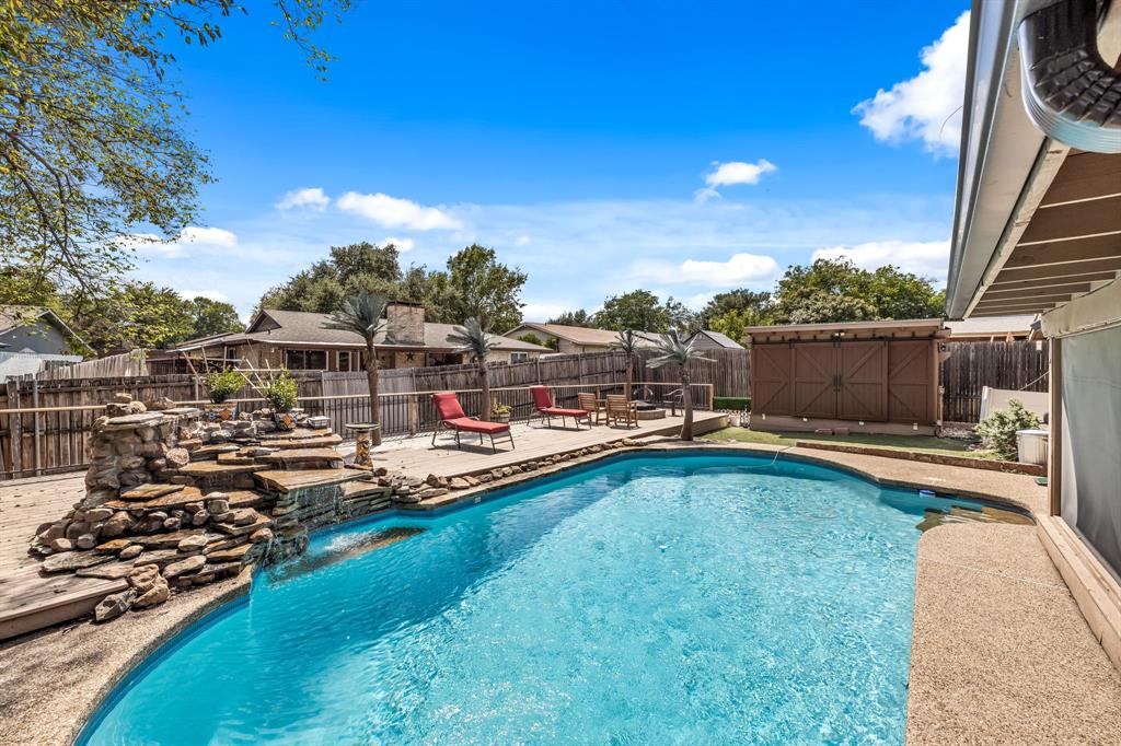 a view of a swimming pool with an outdoor seating and a yard