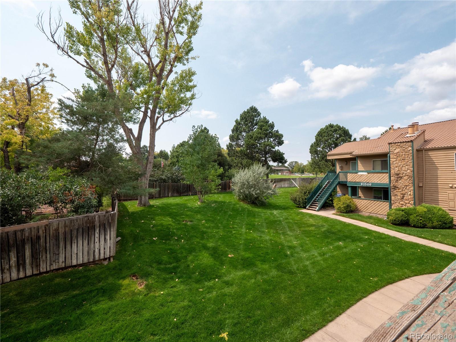 a view of a house with backyard and porch