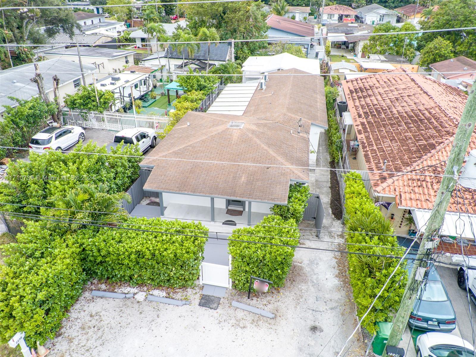 a aerial view of a house with a yard and plants