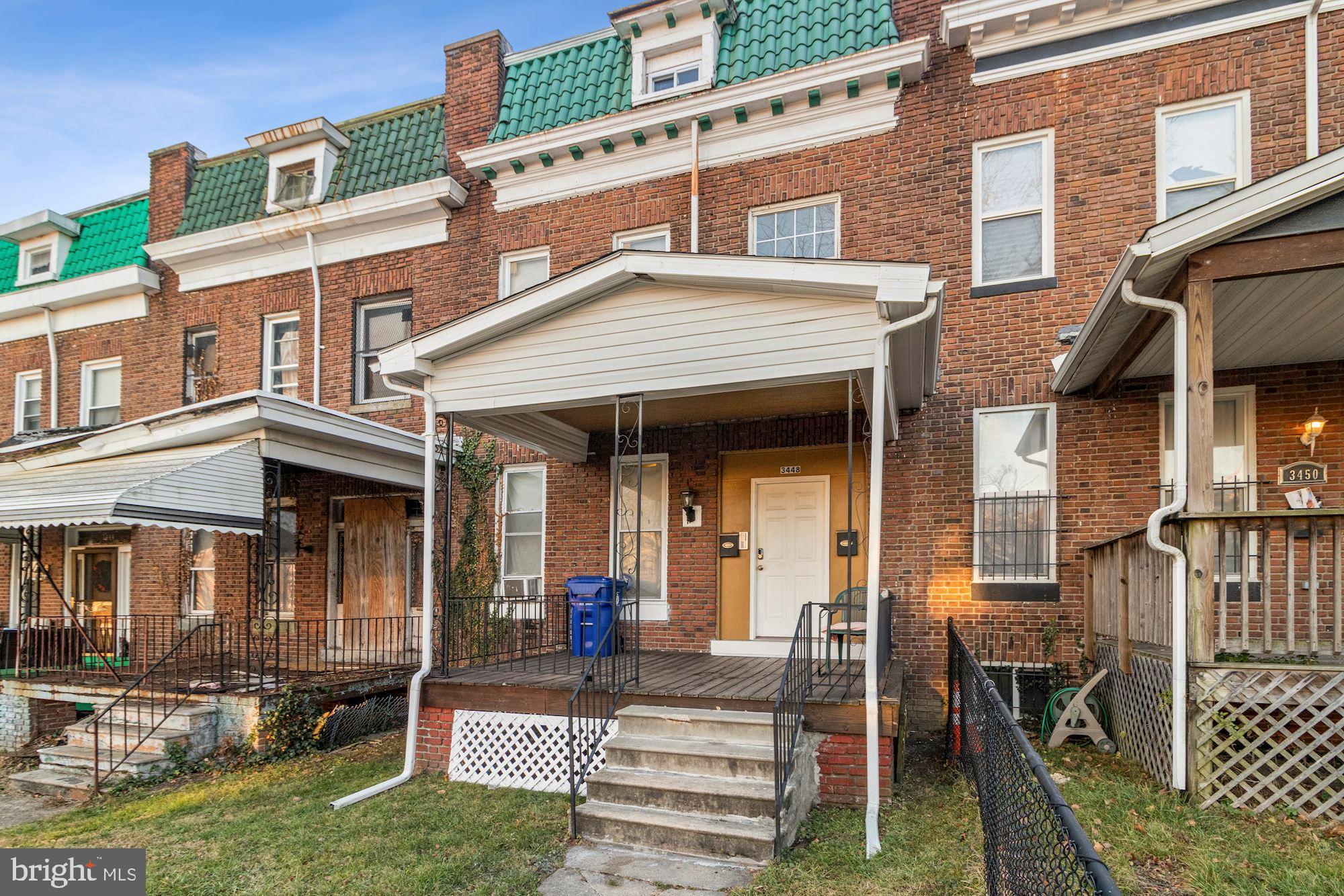 front view of a brick house with a yard