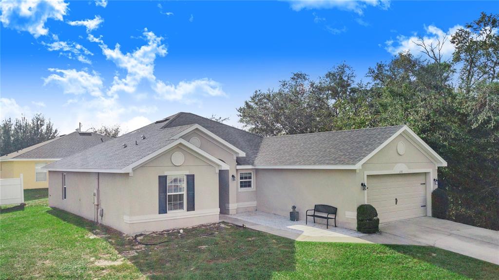 a view of house with yard and entertaining space