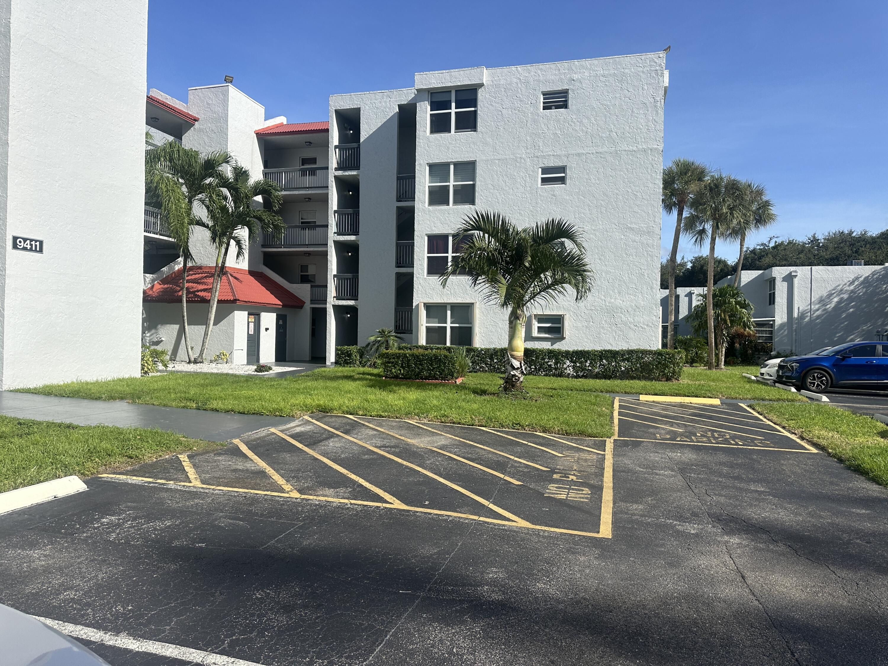 a view of a tall building next to a yard