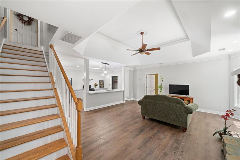 a living room with furniture and a wooden floor