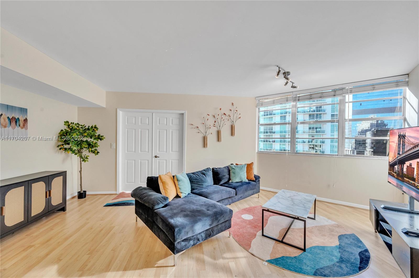 a living room with furniture and a potted plant