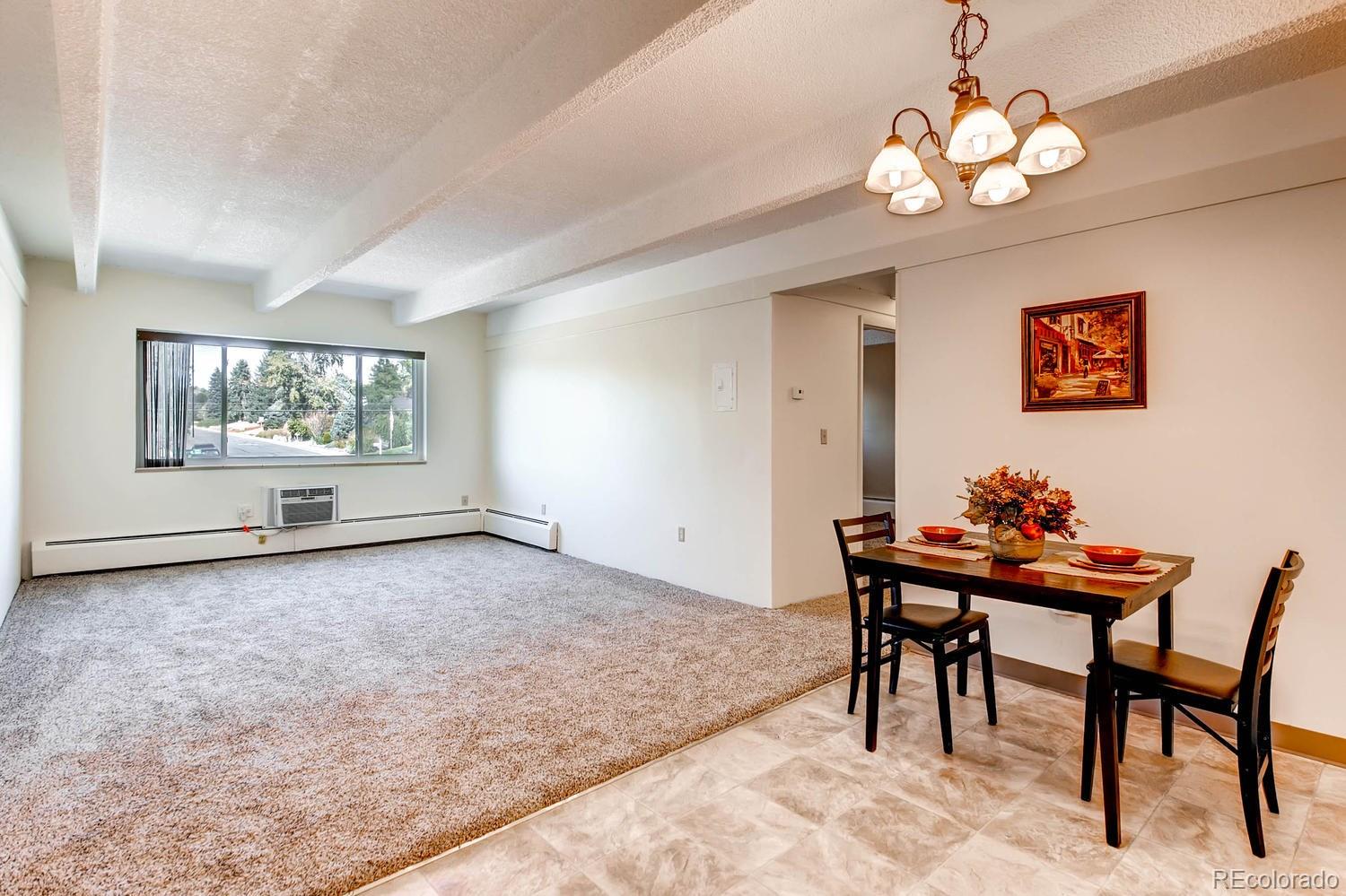 a view of a dining room with furniture and chandelier