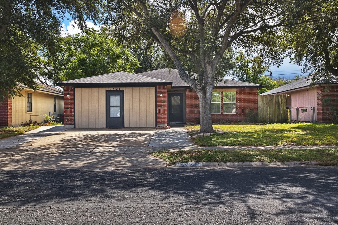 a house that has a tree in front of it