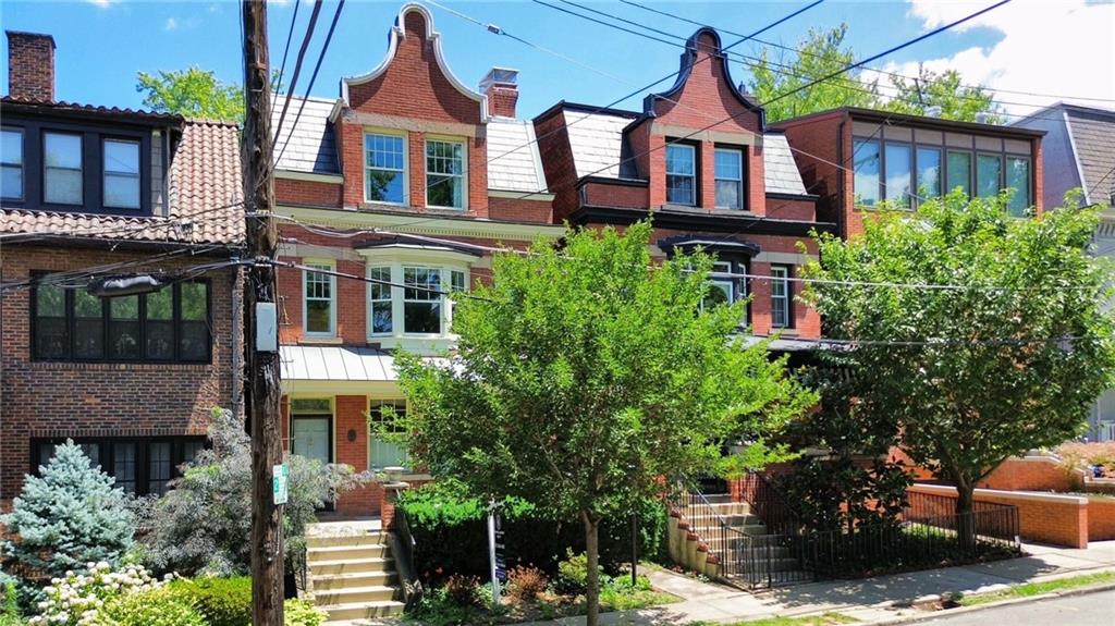 a aerial view of a brick house next to a yard