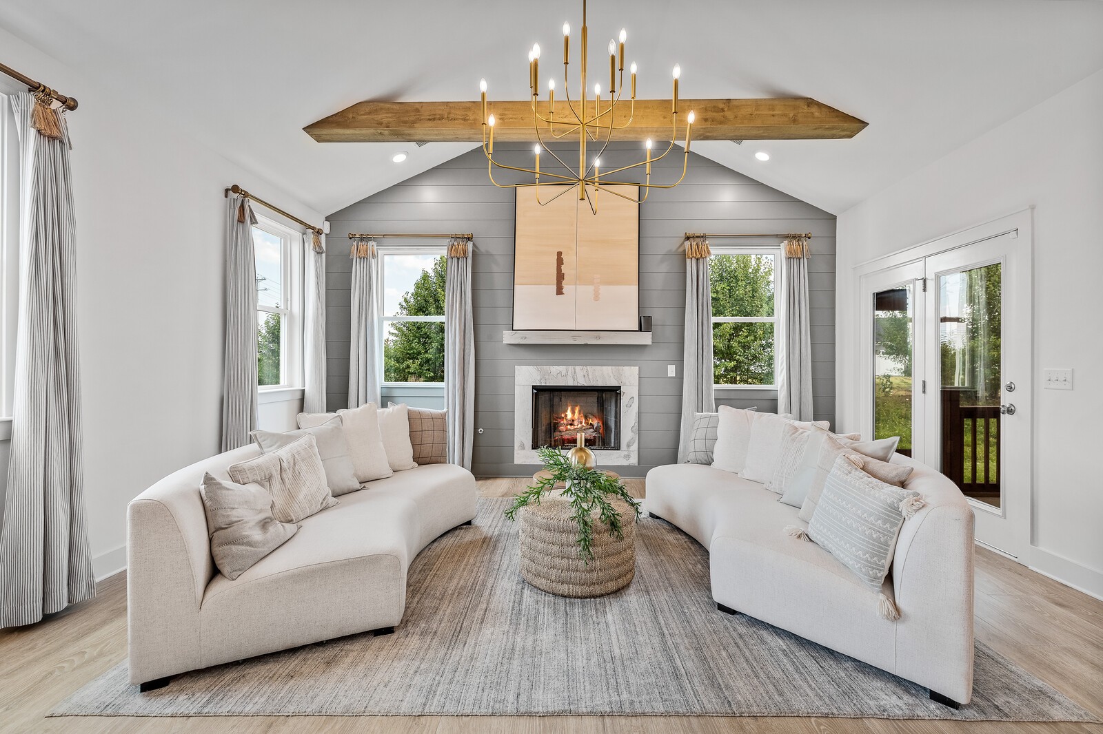 a living room with furniture and a chandelier