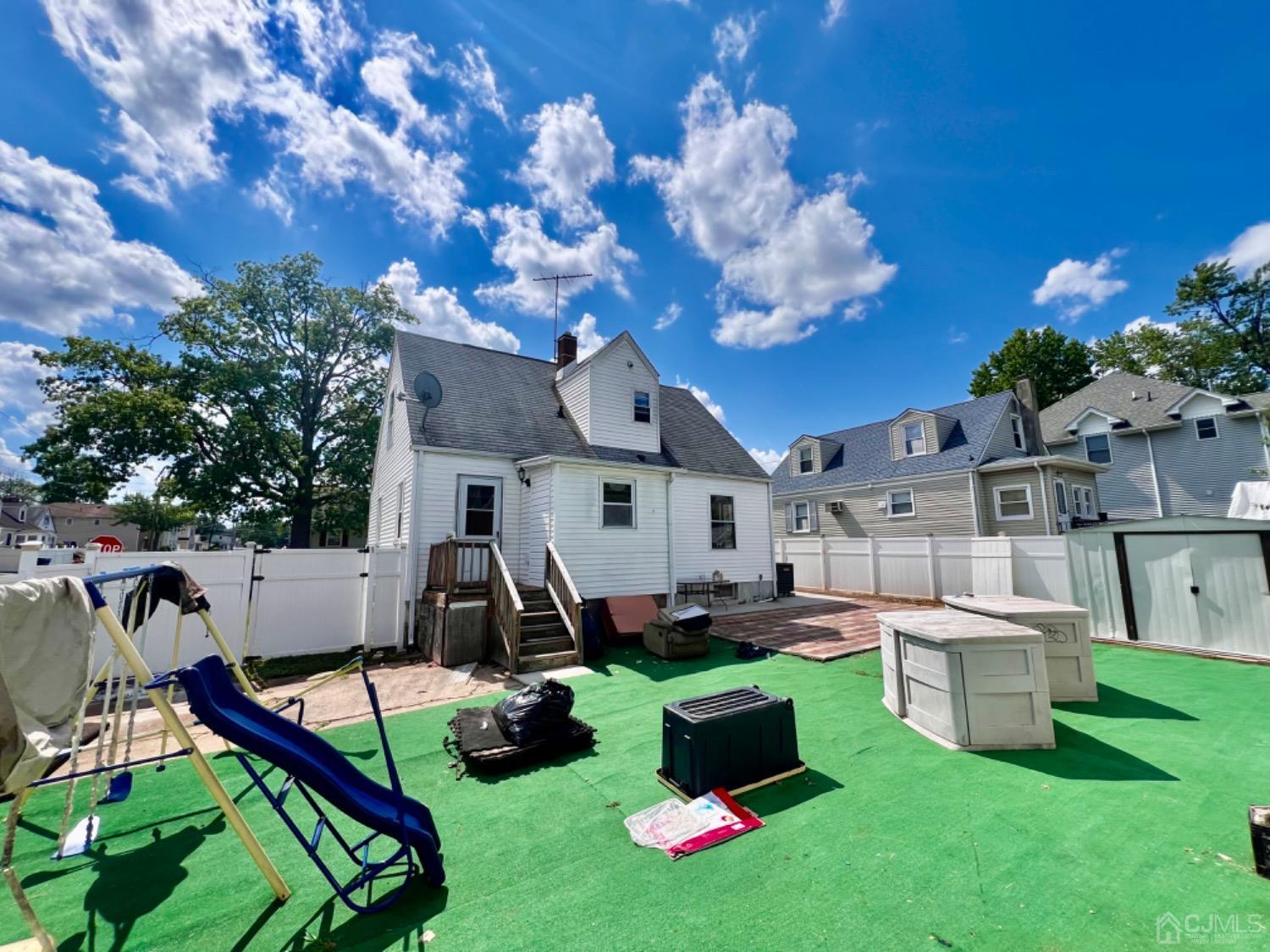 a view of a house with backyard and sitting area