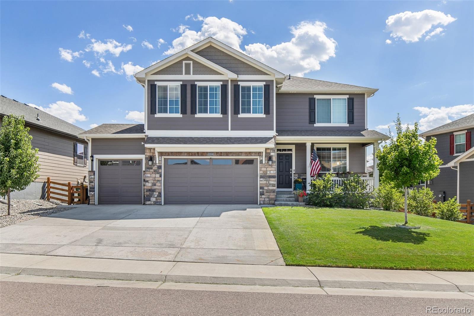 a front view of a house with a yard and garage