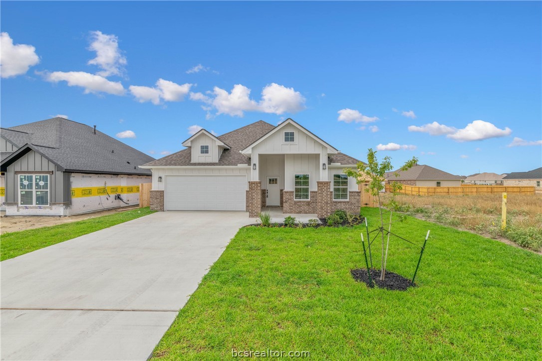 a front view of a house with a yard and entertaining space