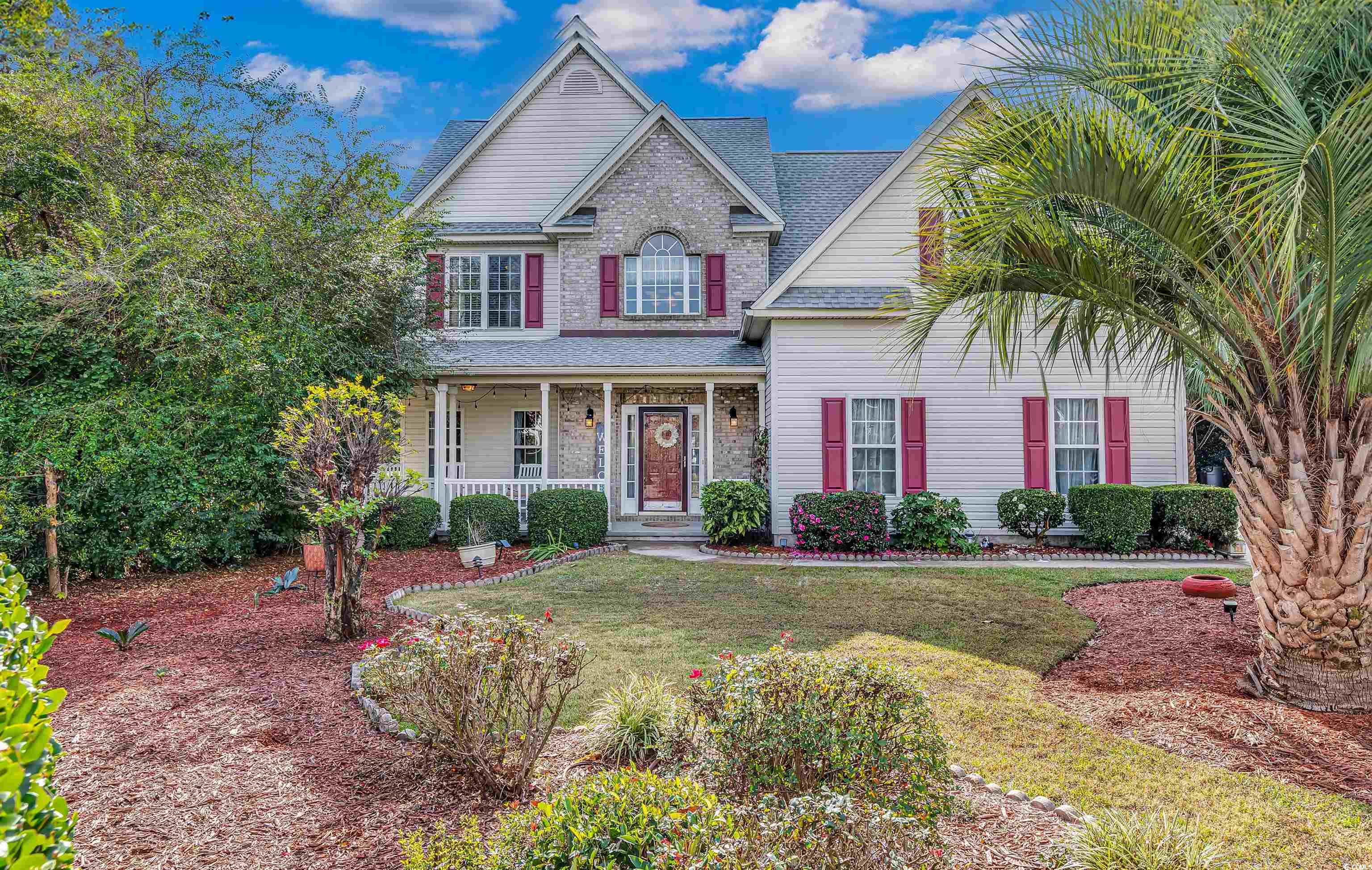 View of front of home with a porch and a front law