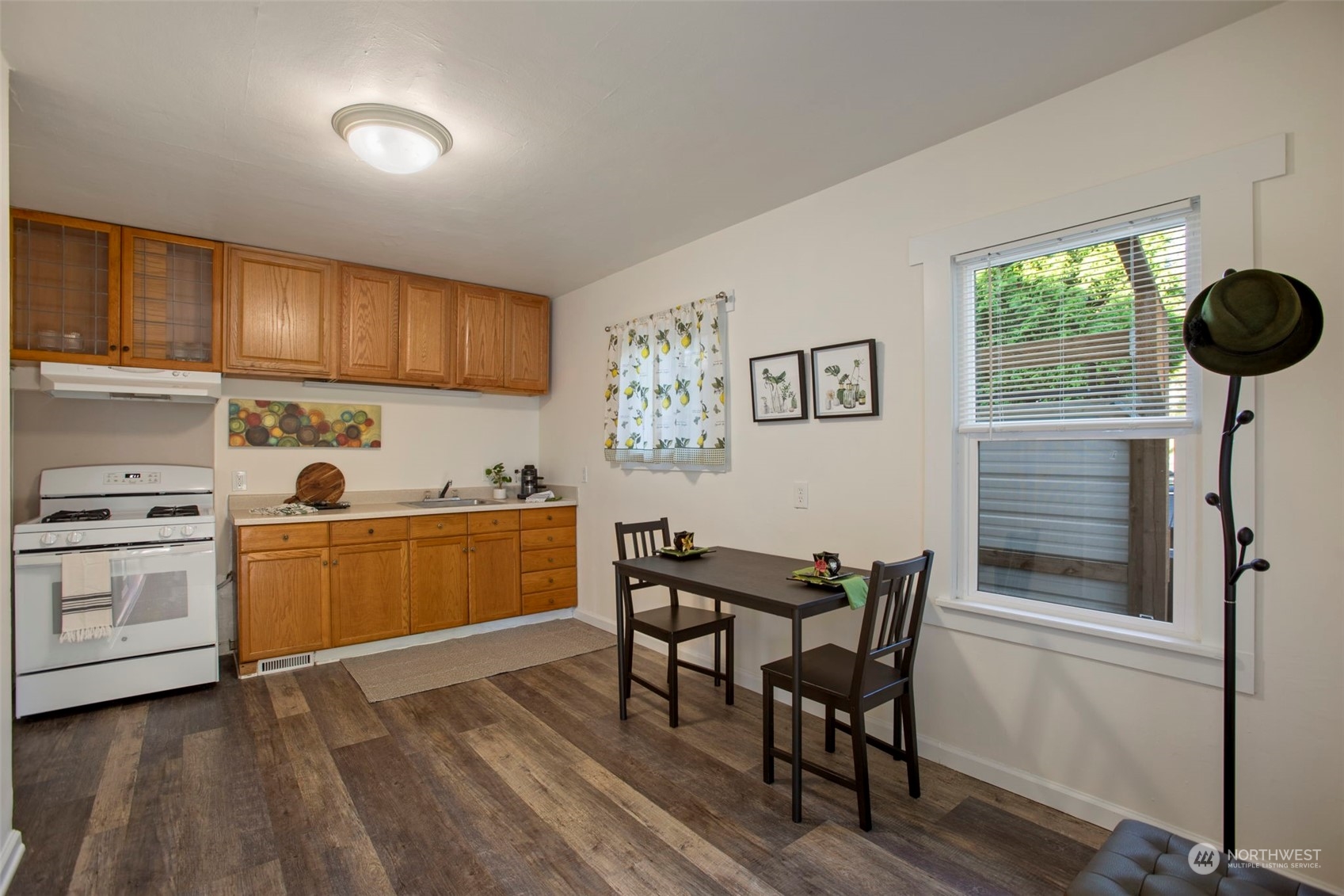 a kitchen with a table chairs refrigerator and cabinets