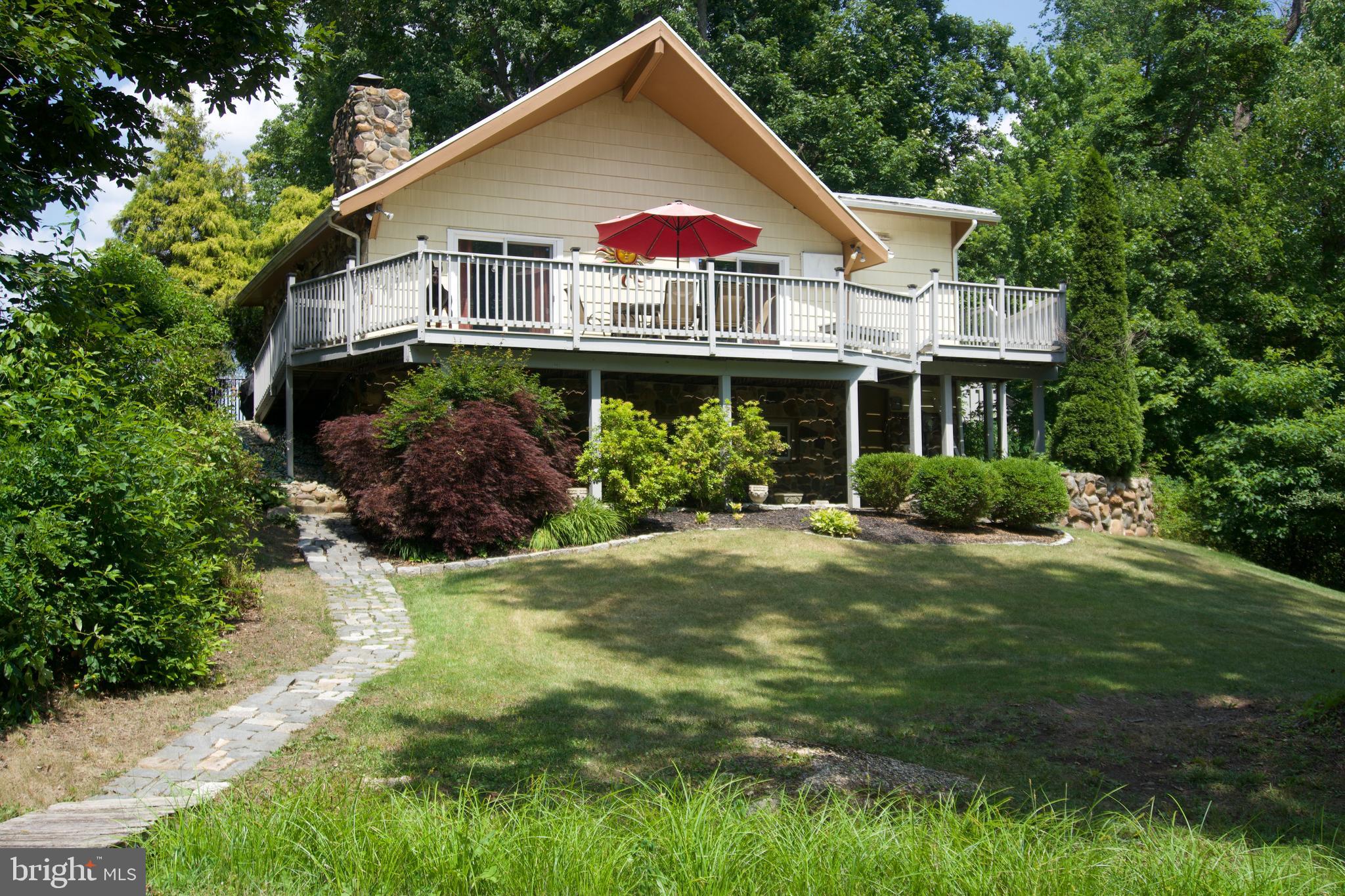 a view of a house with a yard and potted plants