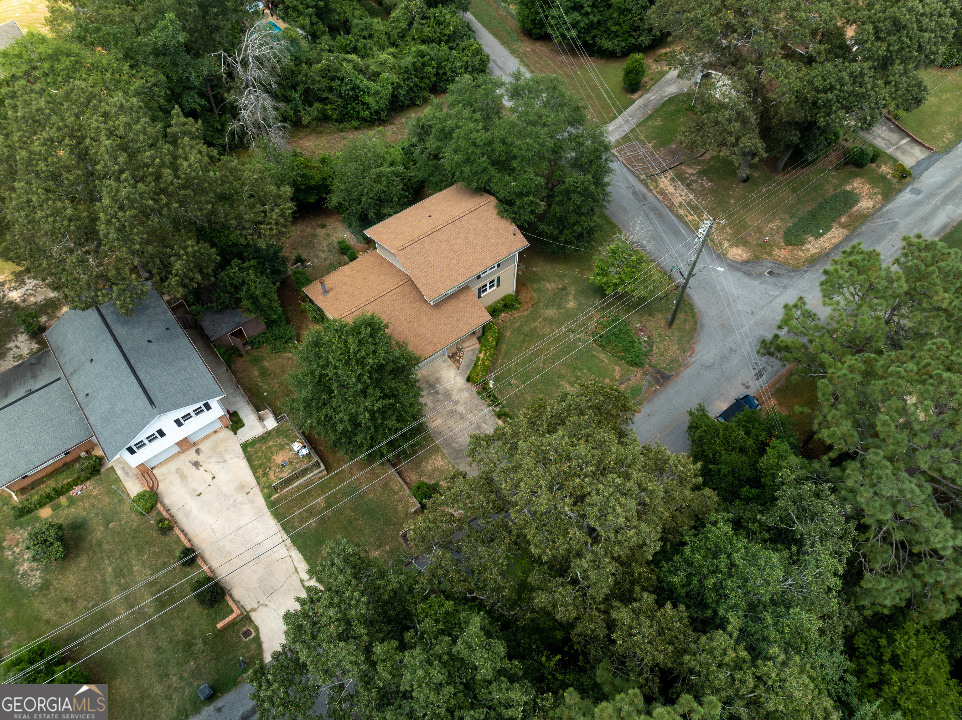 an aerial view of a house with outdoor space and street view